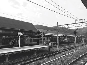 Train at railroad station platform against sky