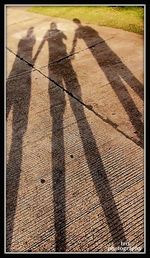 Shadow of people on footpath