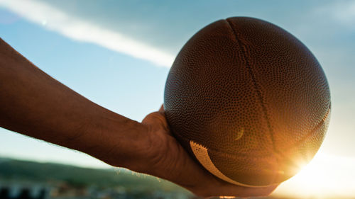 Cropped hand of person holding basketball