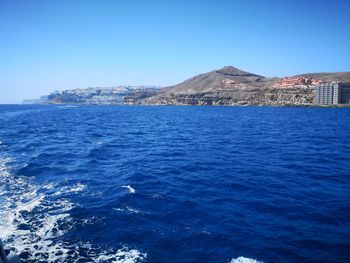 Scenic view of sea against clear blue sky