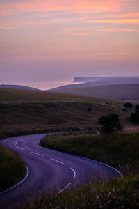 Beachy head z bends. a winding road in east sussex with cliffs and the sea in the distance