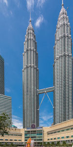 Low angle view of buildings against cloudy sky