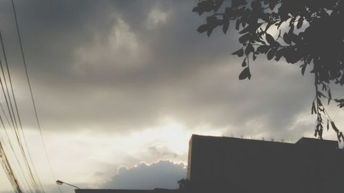 Low angle view of building against cloudy sky