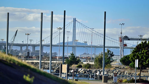 View of suspension bridge against cloudy sky