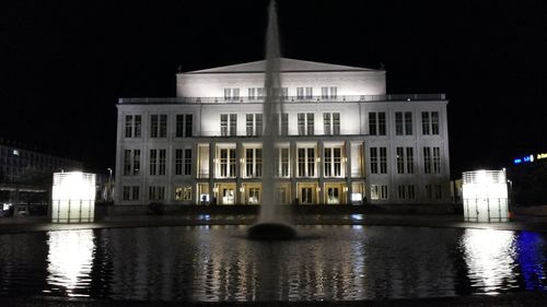 Illuminated buildings with waterfront at night