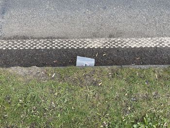 High angle view of road sign on field