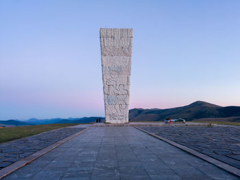 Stone structure against clear blue sky