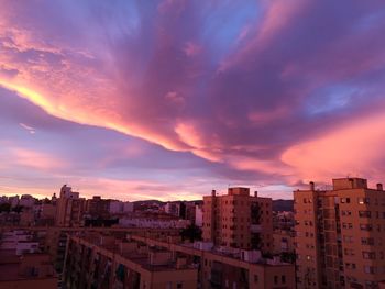 High angle view of buildings against dramatic sky