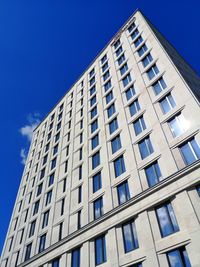 Low angle view of modern building against clear blue sky