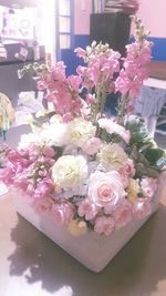 Close-up of pink roses on table