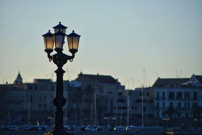 Street light in city against sky