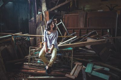 Full length of woman standing on bench