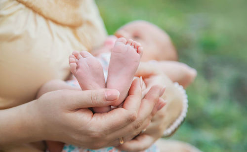 Midsection of woman holding baby