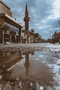 Reflection of tower in puddle