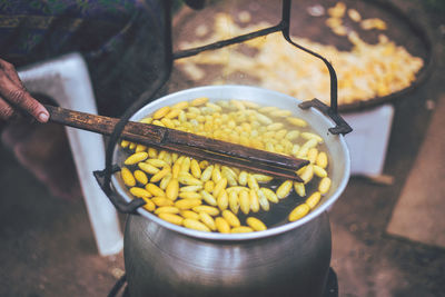 High angle view of hand holding yellow food