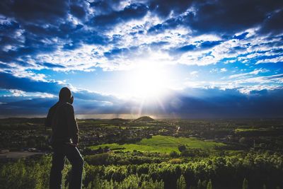 Man standing on field against sky