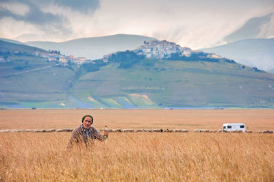 Man on field against mountains