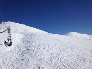 Low angle view of ski lift against sky