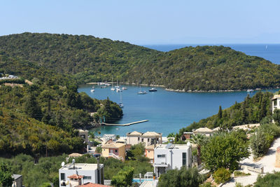 High angle view of buildings by sea against sky