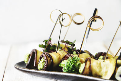 Close-up of served food on table against white background