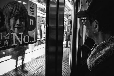 Portrait of man seen through train window