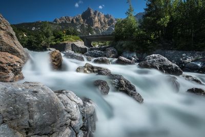 Scenic view of waterfall against sky