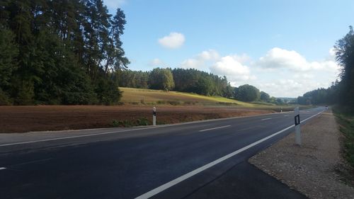 Empty road along countryside landscape