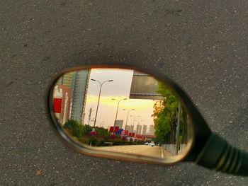 Reflection of road on side-view mirror of car