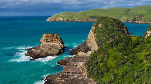 Scenic view of sea and rock formation against sky