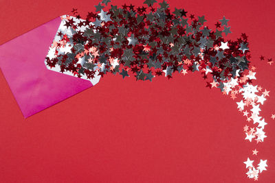 High angle view of flowering plant on table against red background