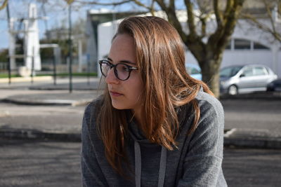 Portrait of young woman in city