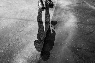 Low section of woman with shadow on leaf