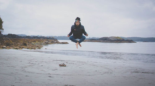 Full length of a man with dog on beach