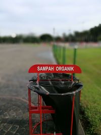 Close-up of sign against sky