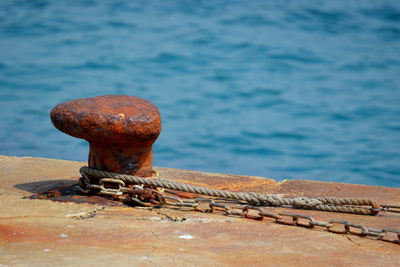 Close-up of rusty metal on pier