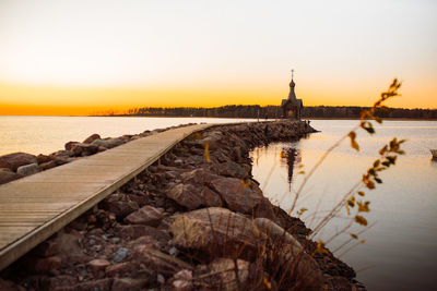 Scenic view of sea against clear sky during sunset