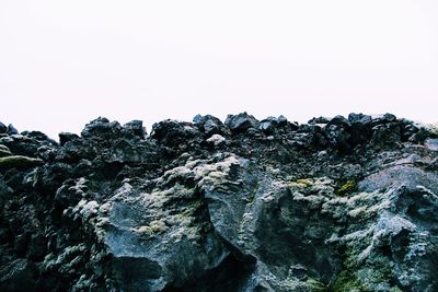 Low angle view of rock formation against clear sky