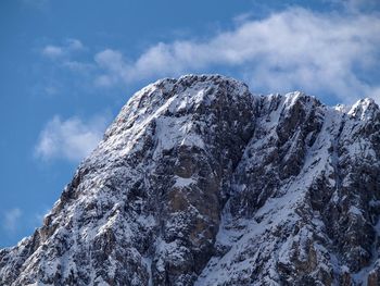 Low angle view of snowcapped mountain against sky