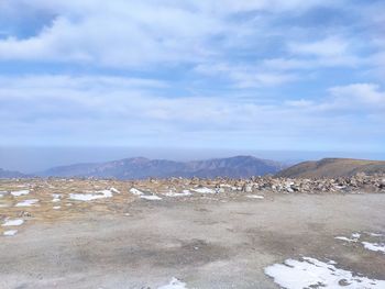 Scenic view of snow covered land against sky