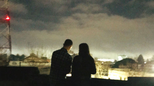 Silhouette couple against sky during sunset