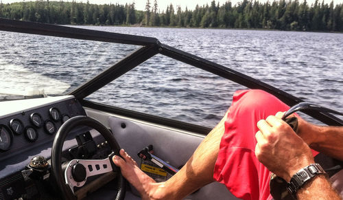 Low section of man on boat sailing in sea