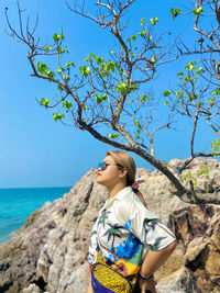 Full length of woman against blue sea against sky