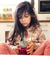 Mid adult woman holding coffee cup