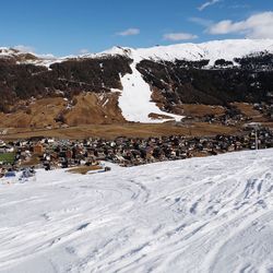 Snow covered landscape against sky