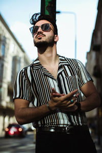 Young man wearing sunglasses standing outdoors