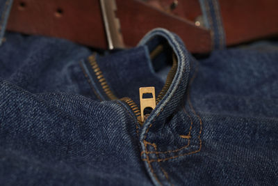 Closeup of zip fastener on blue denim jeans