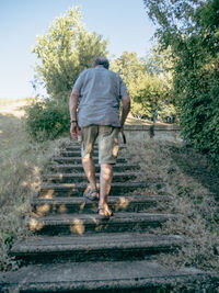 Rear view of man walking on field