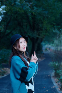 Side view of thoughtful woman standing on road 