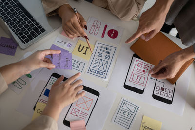 Midsection of business colleagues working on table