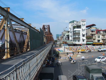 Bridge over road against sky in city